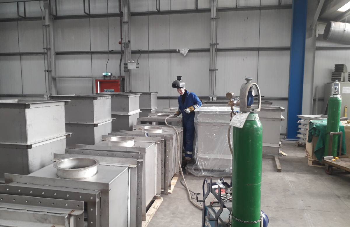 A JGC Engineering engineer fabricating Steel Ductwork with welder