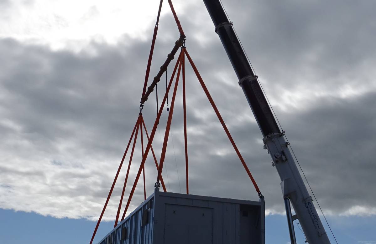 JGC engineering bespoke containers developed by JGC Engineering being lifted onto a platform using a crane operated by JGC engineering