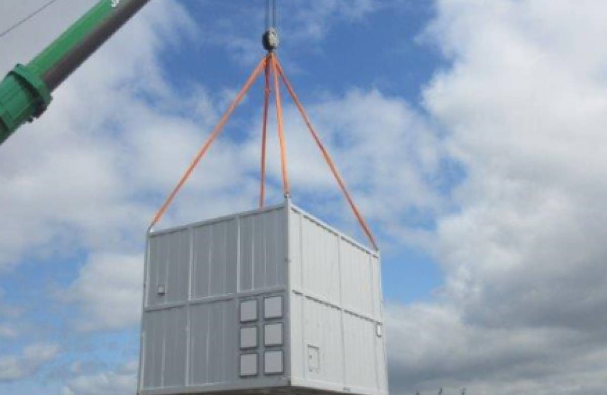 JGC engineering bespoke containers developed by JGC Engineering being lifted onto a platform using a crane operated by JGC engineering at rosyth