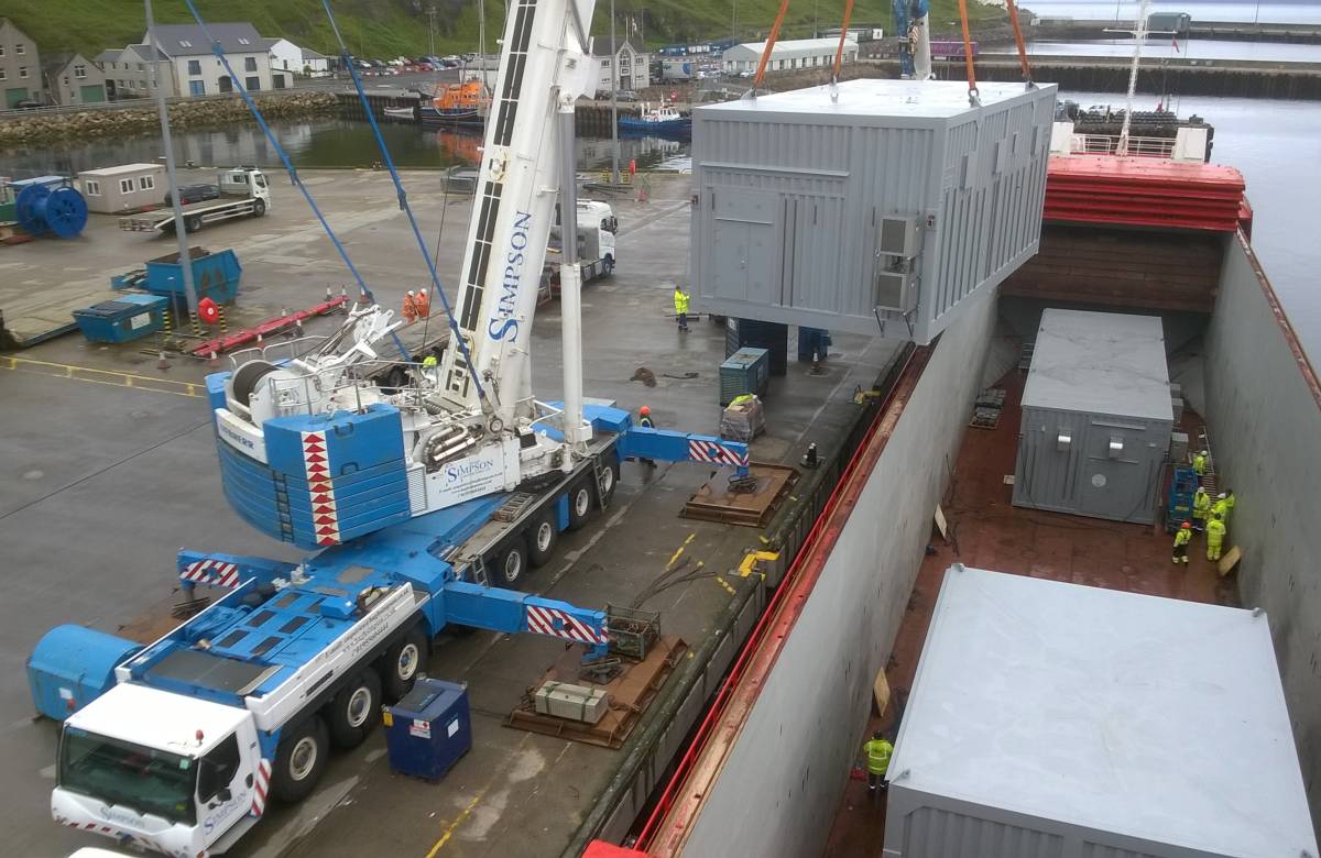 JGC engineering bespoke containers developed by JGC Engineering being lifted onto a ship using a crane operated by JGC engineering at scrabster
