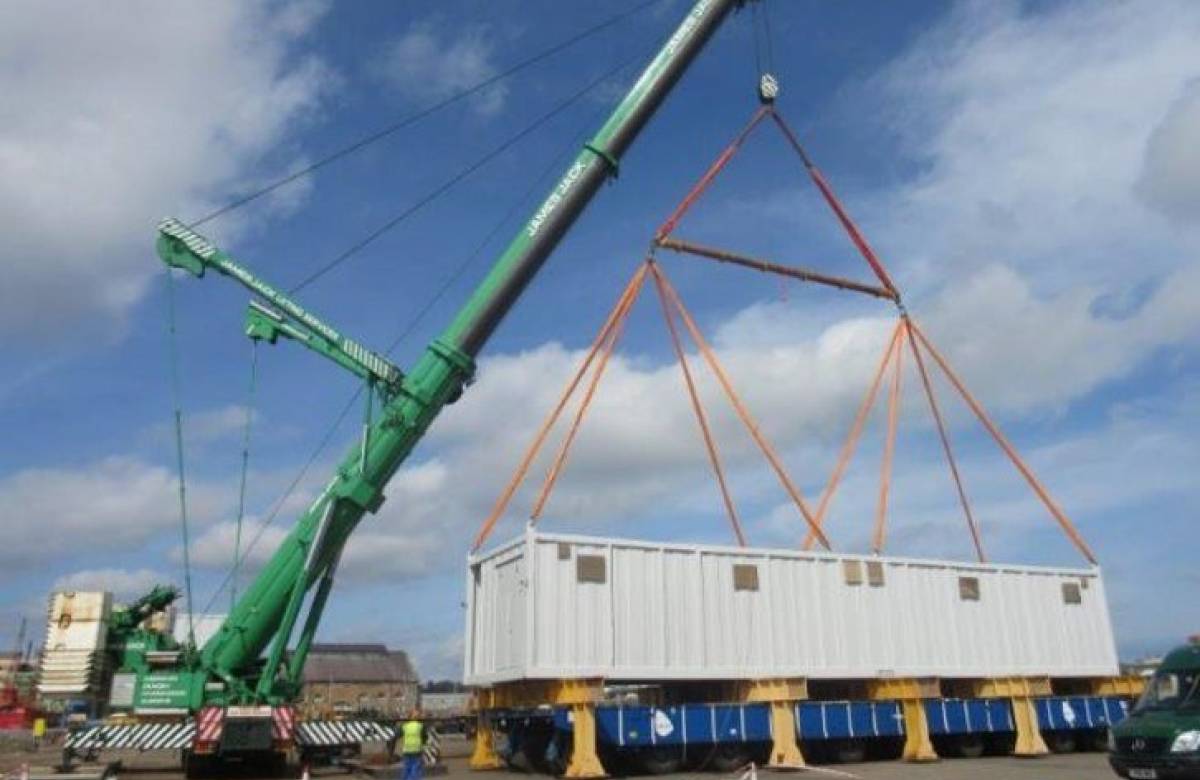 JGC engineering bespoke containers developed by JGC Engineering being lifted onto a platform using a crane operated by JGC engineering at rosyth
