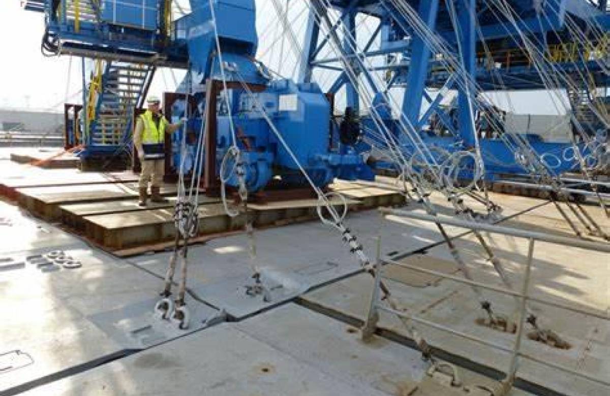 JGC engineering engineer on the dock with large rigging machinery and sea fasteners